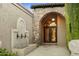 Elegant entryway with stone arch, iron doors, and fountain at 6324 N 48Th Pl, Paradise Valley, AZ 85253