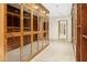 Spacious walk-in closet with ample shelving and glass-door cabinetry at 6324 N 48Th Pl, Paradise Valley, AZ 85253