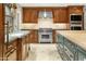Gourmet kitchen with wood cabinetry, island, and high-end appliances at 6324 N 48Th Pl, Paradise Valley, AZ 85253