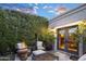 Private patio with fire pit, seating area, and lush greenery at 6324 N 48Th Pl, Paradise Valley, AZ 85253