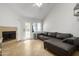 Living room with fireplace, L-shaped sectional sofa, and tiled floors at 19820 N 13Th Ave # 226, Phoenix, AZ 85027