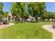 Community green space with mature trees and picnic tables at 19820 N 13Th Ave # 226, Phoenix, AZ 85027