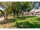 Community green space with picnic tables and mature trees at 19820 N 13Th Ave # 226, Phoenix, AZ 85027