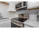 Stainless steel stove top and microwave in updated kitchen at 19820 N 13Th Ave # 226, Phoenix, AZ 85027