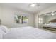 Bright bedroom with mirrored closet doors and ceiling fan at 19820 N 13Th Ave # 226, Phoenix, AZ 85027