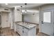 Kitchen with granite island, white cabinets, and access to dining area at 19202 N Signal Butte Cir, Sun City, AZ 85373