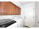 Laundry room with wood cabinets, washer, and dryer at 4306 E Tyson St, Gilbert, AZ 85295
