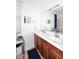 Bright bathroom with double sinks, wood cabinets, and a large mirror at 4306 E Tyson St, Gilbert, AZ 85295