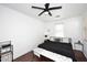 Bright bedroom with a king-size bed, ceiling fan, and wood flooring at 4306 E Tyson St, Gilbert, AZ 85295