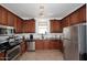 Kitchen with granite countertops, stainless steel appliances, and wooden cabinetry at 4306 E Tyson St, Gilbert, AZ 85295