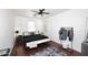Bedroom with king-size bed, ceiling fan, and wood flooring at 4306 E Tyson St, Gilbert, AZ 85295