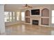 Spacious living room with fireplace, built-in shelves, and tile floors at 11239 E Oberlin Way, Scottsdale, AZ 85262