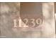 House number 11239 displayed on a stone plaque at 11239 E Oberlin Way, Scottsdale, AZ 85262