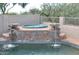 Relaxing spa with waterfall features adjacent to the pool at 11239 E Oberlin Way, Scottsdale, AZ 85262