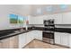 Bright kitchen featuring stainless steel appliances and dark countertops at 10654 E Forge Ave, Mesa, AZ 85208