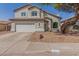 Two-story home with attached garage and landscaping at 10654 E Forge Ave, Mesa, AZ 85208