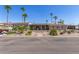 Tan single story home with covered patio and palm trees at 9302 E Broadway Rd # 2, Mesa, AZ 85208