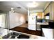 A galley kitchen with wood laminate floors, white appliances, and light wood cabinets at 307 W Mesquite St, Chandler, AZ 85225