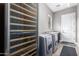 Convenient laundry room with a wine cooler and built-in shelving at 37143 N Greythorn Cir, Carefree, AZ 85377