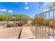 Wooden pathway leading through the desert landscape to the backyard at 37143 N Greythorn Cir, Carefree, AZ 85377