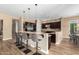 Modern kitchen with dark wood cabinetry, granite counters, and an island at 37143 N Greythorn Cir, Carefree, AZ 85377