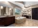 Elegant bathroom with a large soaking tub, double vanities, and a walk-in shower at 37143 N Greythorn Cir, Carefree, AZ 85377