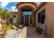 Stone entryway with a dark brown door and desert landscaping at 37143 N Greythorn Cir, Carefree, AZ 85377