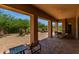 Covered patio with seating area and desert landscaping at 37143 N Greythorn Cir, Carefree, AZ 85377