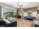 Bedroom with sliding glass doors leading to a patio and wood-look floors at 37143 N Greythorn Cir, Carefree, AZ 85377