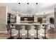 Gourmet kitchen boasts expansive island, stainless steel appliances, and dark wood cabinetry at 37143 N Greythorn Cir, Carefree, AZ 85377