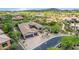 Aerial view of a home with a large yard and two-car garage in a desert community at 37143 N Greythorn Cir, Carefree, AZ 85377