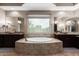 Spa-like bathroom with a large soaking tub, and vanities, and granite countertops at 37143 N Greythorn Cir, Carefree, AZ 85377