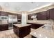 Spacious kitchen with island, stainless steel appliances, and dark wood cabinetry at 37143 N Greythorn Cir, Carefree, AZ 85377