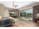 Main bedroom with sliding doors to a patio, a large bed and a built-in workspace at 37143 N Greythorn Cir, Carefree, AZ 85377