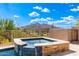 Hot tub with mountain views and a beige tile surround at 37143 N Greythorn Cir, Carefree, AZ 85377