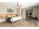 Relaxing bedroom with wood-look floors, a large bed, and access to a work space at 37143 N Greythorn Cir, Carefree, AZ 85377