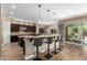 Elegant kitchen with breakfast bar, stainless steel appliances, and custom cabinetry at 37143 N Greythorn Cir, Carefree, AZ 85377