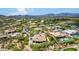 Aerial view of a luxury home community with mountain views and multiple homes with pools at 37143 N Greythorn Cir, Carefree, AZ 85377