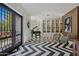Elegant entryway with black and white flooring, piano, and built-in shelving at 2017 N 1St Ave, Phoenix, AZ 85003