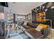 Open concept living room with a brown leather sectional sofa and a modern fireplace at 2017 N 1St Ave, Phoenix, AZ 85003
