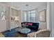 Sophisticated sitting area featuring a blue velvet sofa, built-in shelving, and large windows at 2017 N 1St Ave, Phoenix, AZ 85003