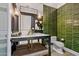 Elegant bathroom with green tile, a floating vanity, and gold fixtures at 2017 N 1St Ave, Phoenix, AZ 85003