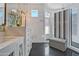 Luxurious bathroom with a walk-in shower, marble tile, and a bench at 2017 N 1St Ave, Phoenix, AZ 85003