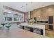 Modern kitchen with an island, brick accent wall, and white cabinetry at 2017 N 1St Ave, Phoenix, AZ 85003