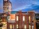 Exterior view of a brick building with rooftop terrace at dusk at 2017 N 1St Ave, Phoenix, AZ 85003