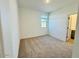 Well-lit bedroom with neutral carpeting and a window at 47287 W Pecan Woods --, Maricopa, AZ 85139