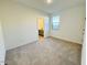 Bright bedroom with neutral carpeting and en-suite bathroom at 47287 W Pecan Woods --, Maricopa, AZ 85139