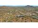 Aerial view of a house and surrounding desert landscape with distant mountains at 10860 E Cactus View Cir, Gold Canyon, AZ 85118