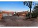 Red brick home with a two car garage and desert landscaping at 56444 N Vulture Mine Rd, Wickenburg, AZ 85390