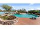 Relax and unwind by the kidney-shaped pool, complete with brick decking and vibrant landscaping at 56444 N Vulture Mine Rd, Wickenburg, AZ 85390